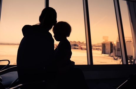 Parent holding child in airport